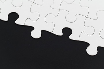 Image showing White puzzle on a black background