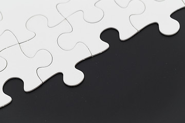 Image showing White puzzle on black background