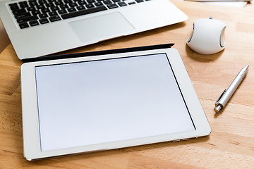 Image showing Working desk with mobile phone and digital tablet showing a whit