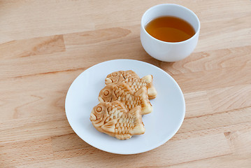 Image showing Japanese confectionery taiyaki fish cake wagashi on plate with t