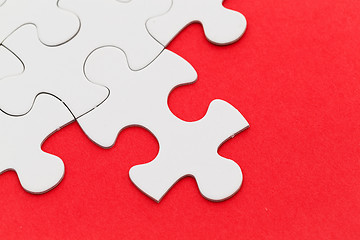 Image showing Jigsaw puzzle with missing red background