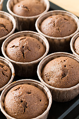 Image showing Fresh muffins on wooden background