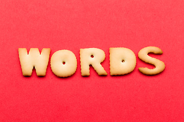 Image showing Words biscuit over the red background