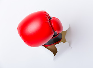 Image showing Punching boxing glove though over paper wall