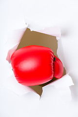 Image showing Punching boxing glove though over white paper