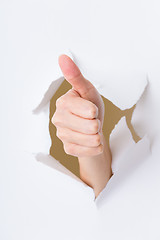 Image showing Hand break through paper with thumb up gesture