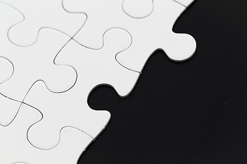 Image showing White puzzle on a black background