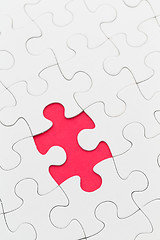 Image showing Plain white jigsaw puzzle with missing piece