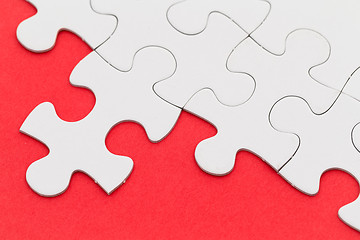 Image showing Jigsaw puzzle over the red background