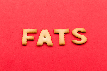 Image showing Word Fats biscuit over the red background