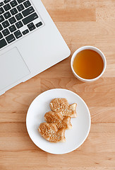 Image showing Computer pc with japanese snack and tea