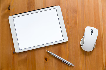 Image showing Digital Tablet, pen and mouse on working desk showing a blank sc