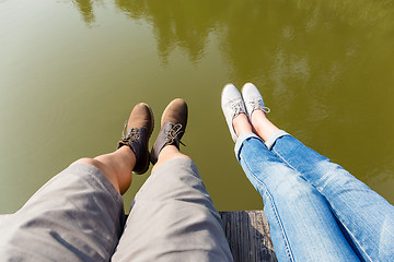 Image showing Couple legs on water lake