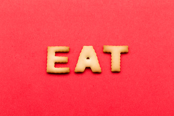 Image showing Word eat cookie over the red background