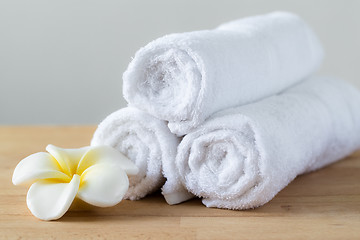 Image showing Frangipani flower with towel won wooden table