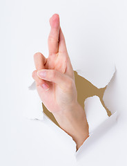 Image showing Lucky sign hand gesture breaking through the paper wall