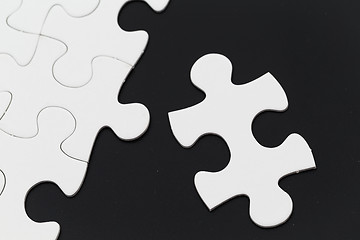 Image showing White puzzle on black background