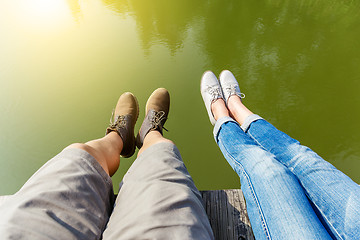 Image showing Woman and man legs in water pond