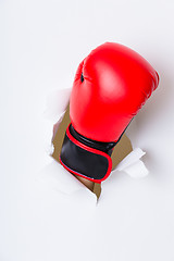 Image showing Hand break through paper with red boxing gloves