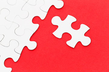 Image showing Jigsaw puzzle on red background 
