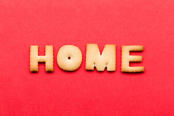 Image showing Word home biscuit over the red background