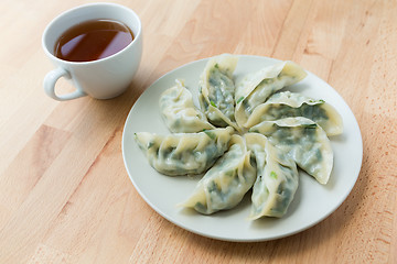 Image showing Chinese dumpling with a cup of tea