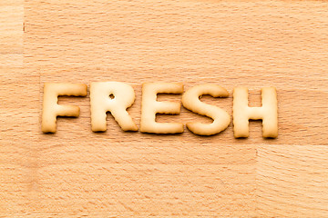 Image showing Word fresh cookie over the wooden background