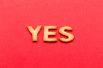 Image showing Word yes biscuit over the red background