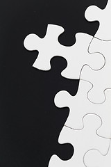 Image showing White puzzle over black background