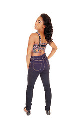 Image showing African American woman in jeans from the back.