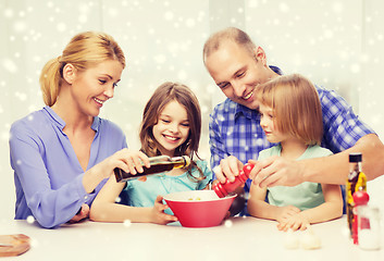 Image showing happy family with two kids making salad at home