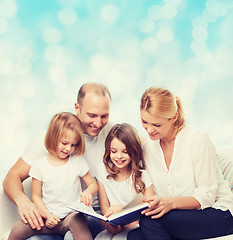 Image showing happy family with book at home