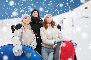 Image showing group of smiling friends with snow tubes