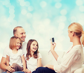 Image showing happy family with camera at home