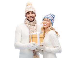 Image showing smiling couple in winter clothes with gift box