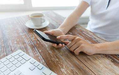 Image showing close up of hands with smart phone at office table