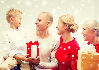 Image showing smiling family with gifts at home