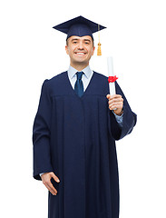 Image showing smiling adult student in mortarboard with diploma