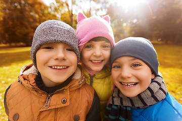 Image showing group of happy children hugging in autumn park