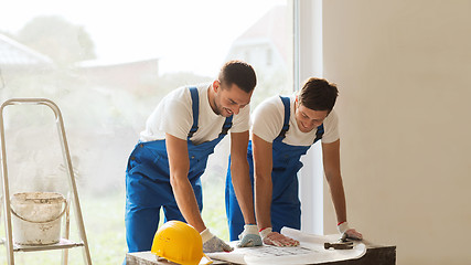 Image showing group of builders with blueprint