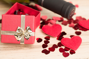 Image showing bottle of vine, red hearts and small present