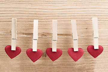 Image showing Red fabric heart hanging on the clothesline