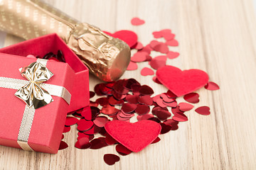 Image showing bottle of vine, red hearts and small present