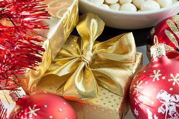 Image showing christmas decoration and golden box with ribbon