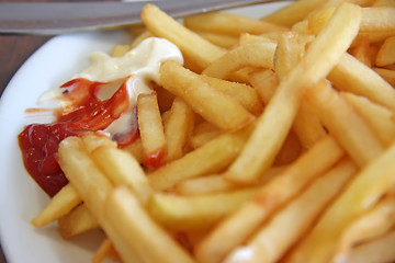 Image showing French fries with condiments