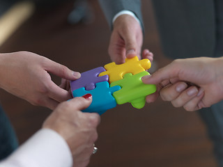 Image showing business people group assembling jigsaw puzzle