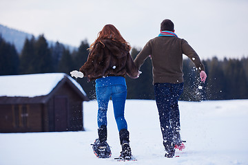 Image showing couple having fun and walking in snow shoes