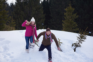 Image showing couple having fun and walking in snow shoes