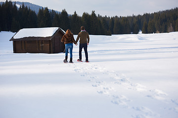 Image showing couple having fun and walking in snow shoes