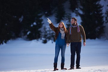 Image showing couple having fun and walking in snow shoes